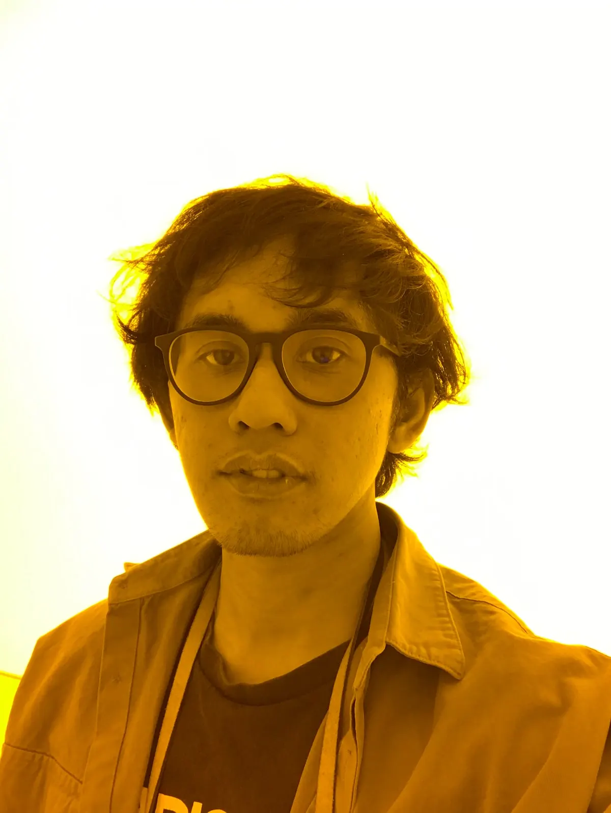 Rizal, co-founder of Temali Studio, in a yellow-toned portrait